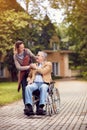 Caregiver daughter with senior man in wheelchair Royalty Free Stock Photo