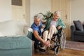 Caregiver doing regular check-up of senior woman in her home. Royalty Free Stock Photo