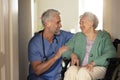 Caregiver doing regular check-up of senior woman in her home. Royalty Free Stock Photo