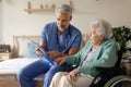 Caregiver doing regular check-up of senior woman in her home. Royalty Free Stock Photo