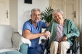 Caregiver doing regular check-up of senior woman in her home. Royalty Free Stock Photo