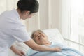 Caregiver in elderly homeycare giving help grandma.