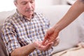 Caregiver giving the medicine to older male patient