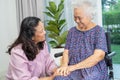 Caregiver help and care Asian senior or elderly old lady woman patient sitting on wheelchair at home Royalty Free Stock Photo