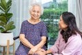 Caregiver help and care Asian senior or elderly old lady woman patient sitting on wheelchair at home Royalty Free Stock Photo