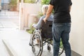 Caregiver help and care Asian senior or elderly old lady woman patient sitting on wheelchair at nursing hospital ward, healthy Royalty Free Stock Photo