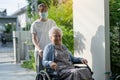 Caregiver help and care Asian senior or elderly old lady woman patient sitting on wheelchair to ramp in nursing hospital, healthy Royalty Free Stock Photo