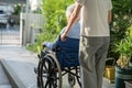 Caregiver help and care Asian senior or elderly old lady woman patient sitting on wheelchair to ramp in nursing hospital, healthy Royalty Free Stock Photo