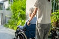 Caregiver help and care Asian senior or elderly old lady woman patient sitting on wheelchair to ramp in nursing hospital, healthy Royalty Free Stock Photo