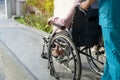 Caregiver help and care Asian senior or elderly old lady woman patient sitting on wheelchair to ramp in nursing hospital, healthy Royalty Free Stock Photo