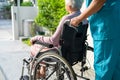 Caregiver help and care Asian senior or elderly old lady woman patient sitting on wheelchair to ramp in nursing hospital, healthy Royalty Free Stock Photo