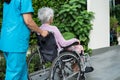 Caregiver help and care Asian senior or elderly old lady woman patient sitting on wheelchair to ramp in nursing hospital, healthy Royalty Free Stock Photo