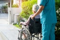 Caregiver help and care Asian senior or elderly old lady woman patient sitting on wheelchair to ramp in nursing hospital, healthy Royalty Free Stock Photo