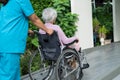 Caregiver help and care Asian senior or elderly old lady woman patient sitting on wheelchair to ramp in nursing hospital, healthy Royalty Free Stock Photo