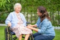 Caregiver help and care Asian senior woman patient sitting on wheelchair at nursing hospital ward, healthy strong medical Royalty Free Stock Photo
