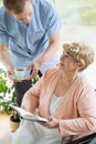 Caregiver helping disabled pensioner Royalty Free Stock Photo