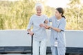 Caregiver helping senior woman to walk Royalty Free Stock Photo
