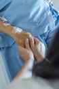 Caregiver Holding Elderly Senior Patient Ageing Old Adult Person Hand In Hospital Bed Or Nursing Hospice