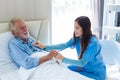 Caregiver nurse using stethoscope checking to Senior patient. Nurse helping stethoscope checking patient for listening heart rate Royalty Free Stock Photo