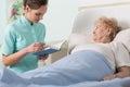 Caregiver reading ill patient book