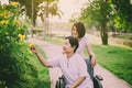 Caregiver take care to elderly asian woman sitting on wheelchair,Senior care insurance concept