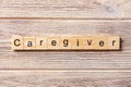 Caregiver word written on wood block. Caregiver text on table, concept Royalty Free Stock Photo