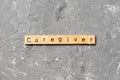 Caregiver word written on wood block. Caregiver text on table, concept Royalty Free Stock Photo
