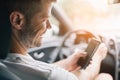 Careless driver using a mobile phone whilst driving Royalty Free Stock Photo