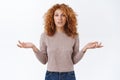Careless, indifferent arrogant redhead woman with curly hair, wear blouse, shrugging indecisive, spread arms sideways