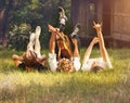 Careless teenagers lying on the green lawn with guitar