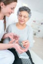 Carer administering medication to elderly lady Royalty Free Stock Photo