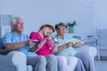 Carer playing video games with elderly couple Royalty Free Stock Photo