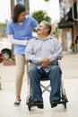 Carer Pushing Disabled Senior Man In Wheelchair Royalty Free Stock Photo