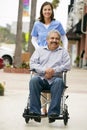 Carer Pushing Disabled Senior Man In Wheelchair Royalty Free Stock Photo