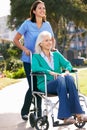 Carer Pushing Senior Woman In Wheelchair Royalty Free Stock Photo