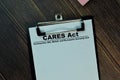 Cares Act write on a paperwork isolated on Wooden Table