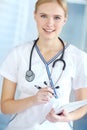 She cares about her patients. Portrait of a smiling nurse writing notes in her notepad. Royalty Free Stock Photo