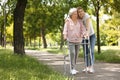 Caretaker helping elderly woman with walking frame Royalty Free Stock Photo