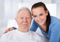 Caretaker with senior man at nursing home