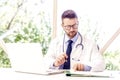 Careworn male doctor working on laptop and desk in the hospital Royalty Free Stock Photo