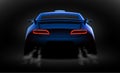 Realistic blue sport car back view with unlocked rear lights in the dark Royalty Free Stock Photo