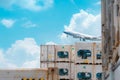 Cargo airplane flying above logistic container. Air logistic. Reefer for frozen food. Refrigerated container for export and import