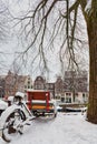 Cargo bicycle covered with snow in front of an Amsterdam canal during winter Royalty Free Stock Photo