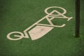 A cargo bike symbol painted on green asphalt indicates a dedicated load bike parking slot