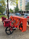 Cargo bikes parked in a row on the sidewalk