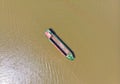 Cargo boat floating on the Mekong River Delta region, Can Tho, South Vietnam. Directly above top down nautical vessel on brown Royalty Free Stock Photo