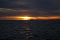 Cargo boat on the horizon at sunrise