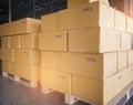 Cargo boxes shipment, Manufacturing and warehousing. Stack of cardboard boxes on pallet and hand pallet truck at warehouse storage Royalty Free Stock Photo