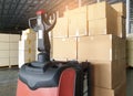 Stack of cardboard boxes on pallet and forklift pallet jack at the warehouse storage. Royalty Free Stock Photo