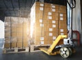 Cargo boxes, Shipment. Stacked of package boxes with hand pallet truck at the warehouse storage. Manufacturing and warehousing. Royalty Free Stock Photo